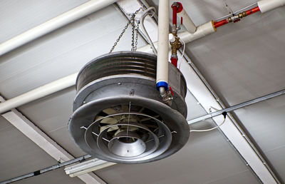 Low angle view of electric lamp hanging on ceiling