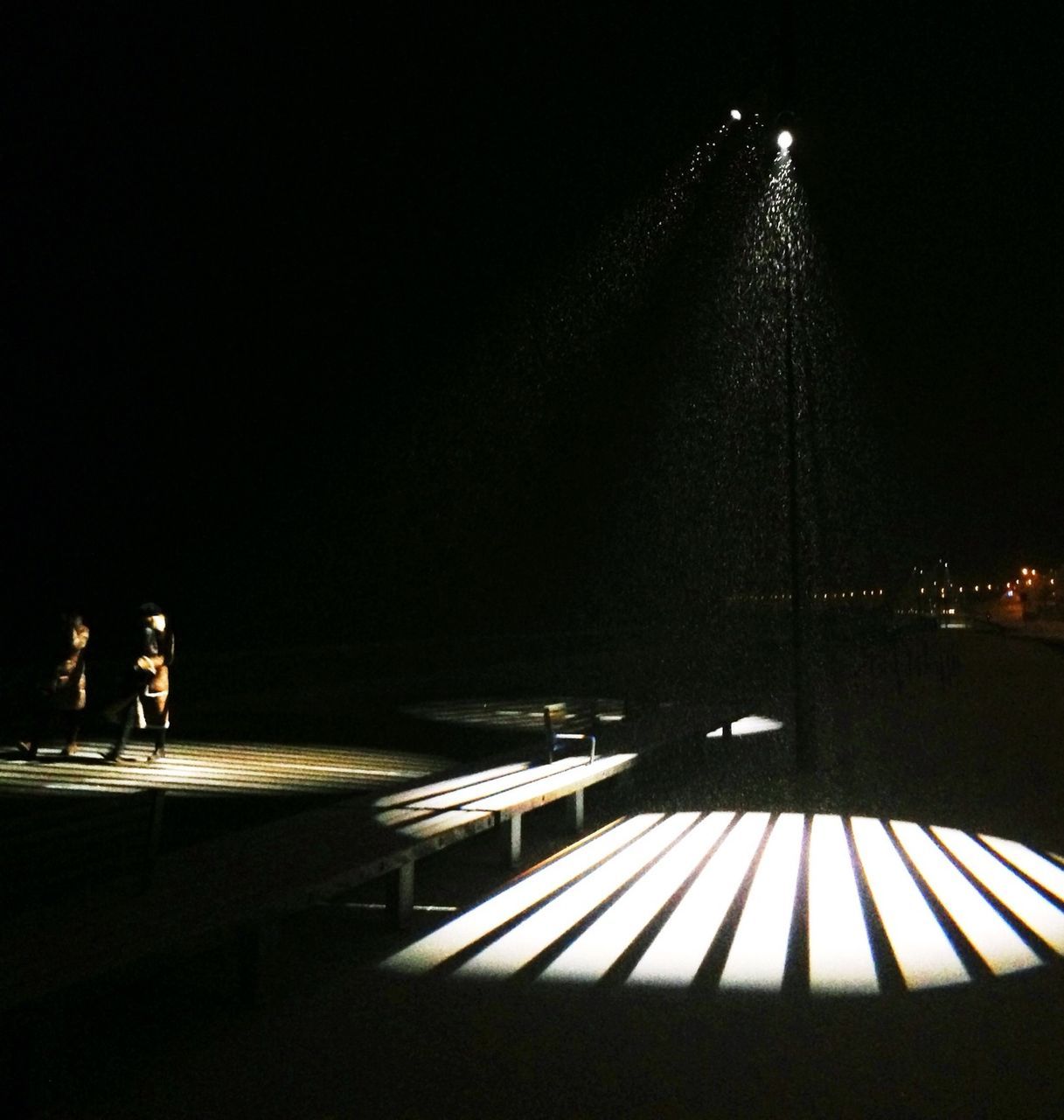 night, illuminated, men, lifestyles, dark, person, copy space, unrecognizable person, leisure activity, walking, rear view, standing, lighting equipment, built structure, the way forward, water, outdoors, street