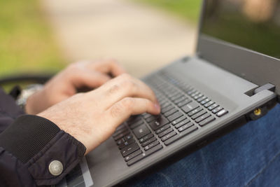 Midsection of man using laptop