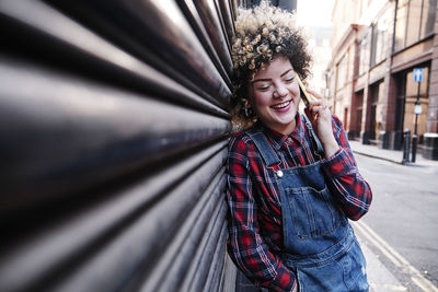 Portrait of smiling young woman standing outdoors