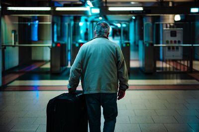 Rear view of man walking in airport