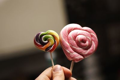 Close-up of hand holding lollipops