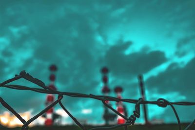 Low angle view of fence against sky at night