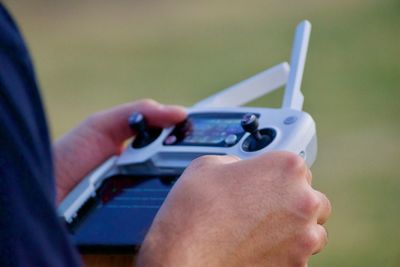 Cropped hands holding remote control