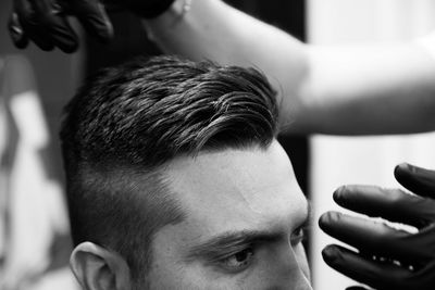 Barber setting hair of man in the barber shop