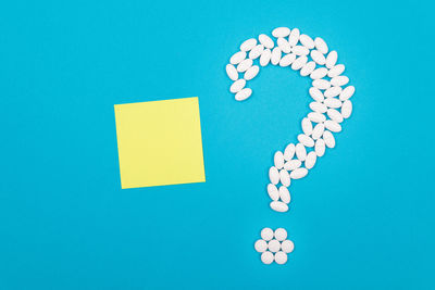 Directly above shot of colored pencils over blue background