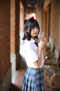 Portrait of girl standing in corridor