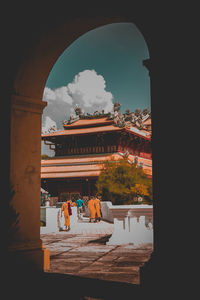 People looking at view of buildings against sky