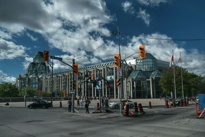 Modern buildings against cloudy sky