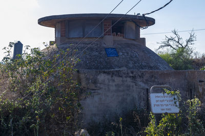 View of sign on building against sky