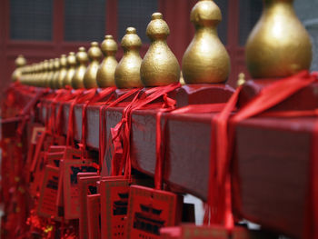 Religious equipments hanging on fence in temple