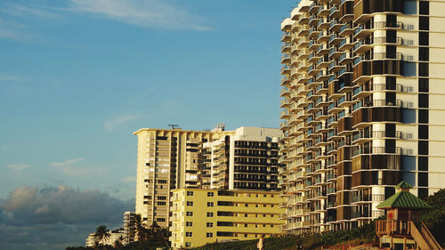 Low angle view of condominiums against sky