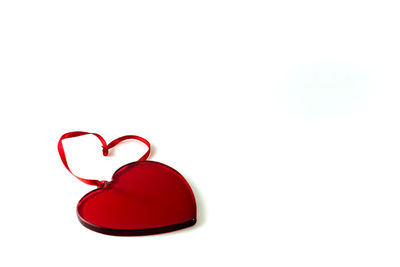 Close-up of red heart shape over white background
