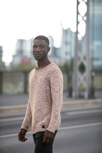 Portrait of young man standing on street