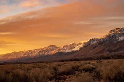 Scenic view of snowcapped mountains against sky during sunset