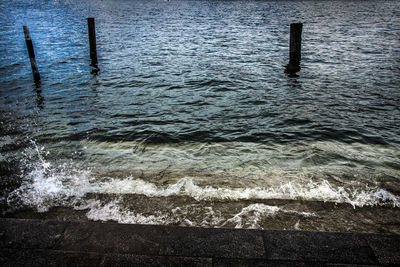 High angle view of wooden posts in sea