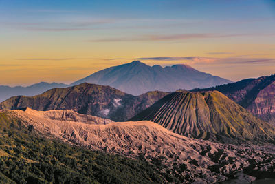 Scenic view of mountain range against sky during sunset