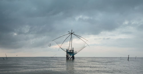 Sailboat in sea against sky