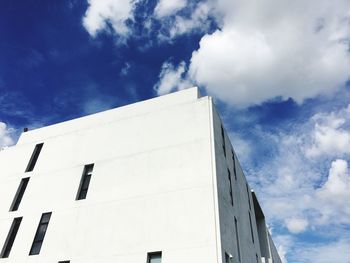 Low angle view of building against cloudy sky