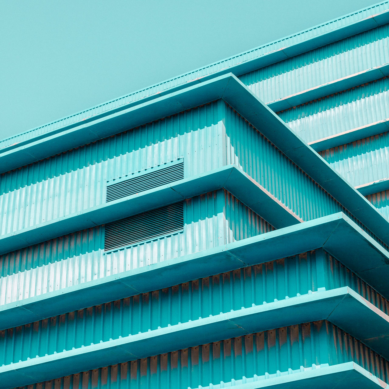 architecture, built structure, pattern, building exterior, low angle view, no people, blue, building, repetition, day, clear sky, full frame, sky, modern, nature, backgrounds, side by side, outdoors, sunlight, metal, turquoise colored