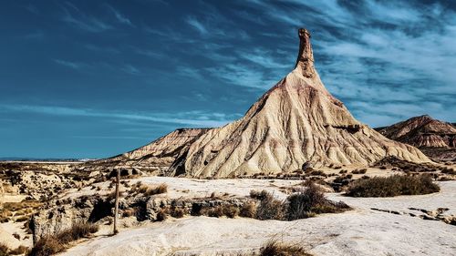 Rock formations on landscape against sky