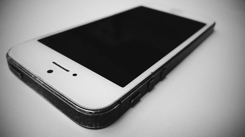 Close-up of mobile phone over white background