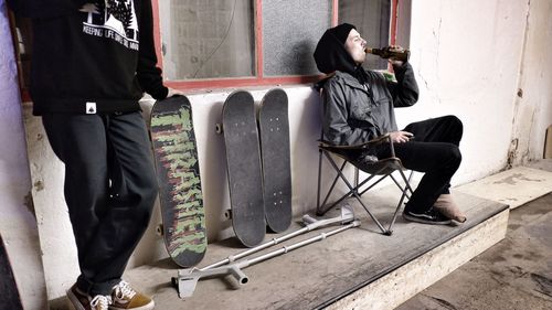 Low section of men sitting on floor in city