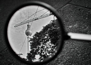 Fernsehturm tower reflecting on side-view mirror of vehicle