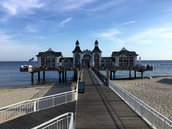 View of pier on sea against buildings