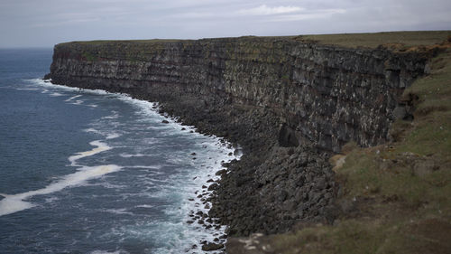 Scenic view of sea against cloudy sky