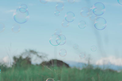 Close-up of bubbles against sky