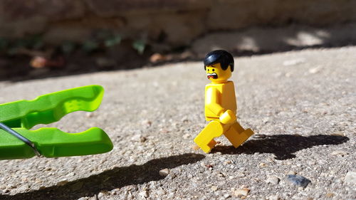 Close-up of yellow toy on leaf