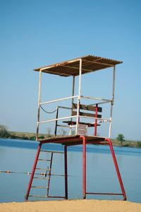 Lifeguard hut on beach against clear sky