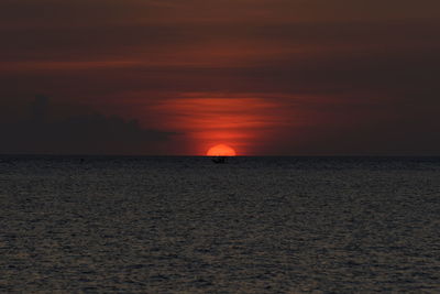 Scenic view of sea against orange sky