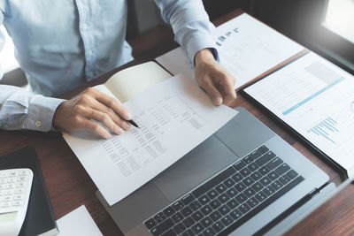 Low angle view of man using laptop on table