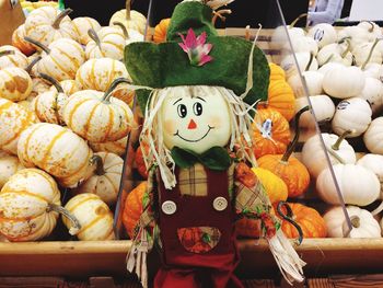 Close-up of toy against pumpkins at market