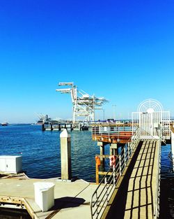 View of harbor against clear blue sky