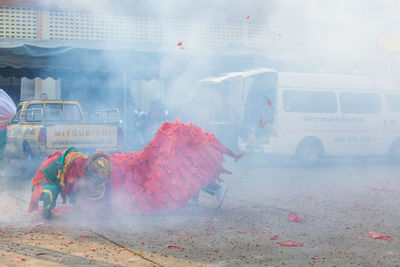 Traditional dragon dance and smoke on street