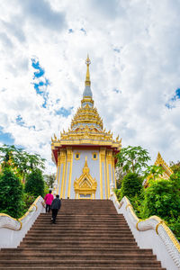 Low angle view of temple building against cloudy sky