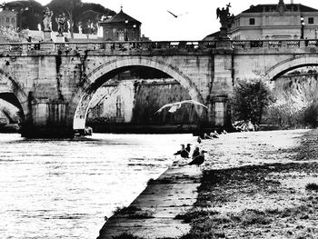 Arch bridge over river in city