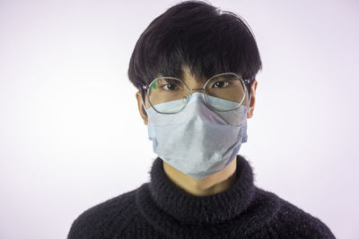 Close-up portrait of young man against white background