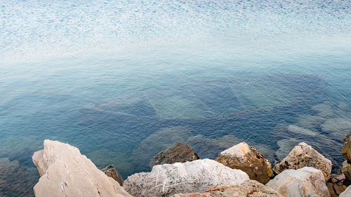 High angle view of rocks by sea