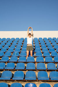 Full length of woman against blue sky