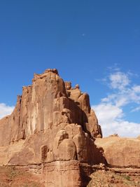 Scenic view of rocky mountains against blue sky