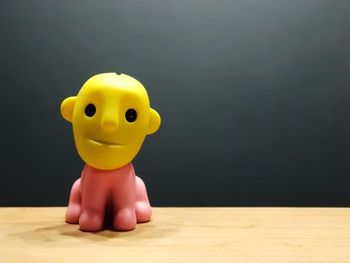 Close-up of toy on table against gray background