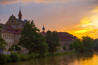 Buildings against sky at sunset