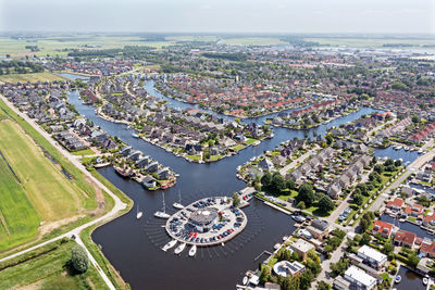 Aerial top shot from houses with boats in friesland the netherlands