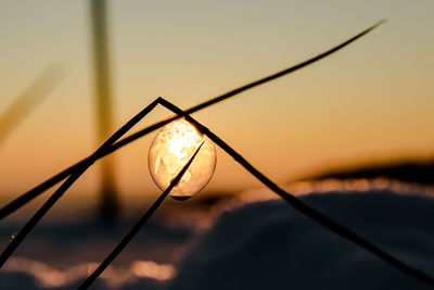 Close-up of water against sky at sunset