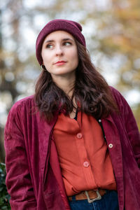 Portrait of beautiful young woman standing in winter