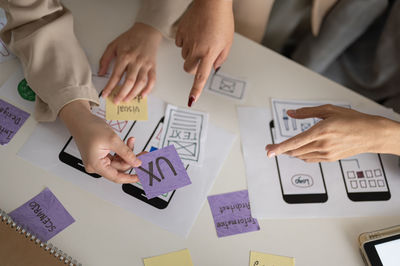 Midsection of business colleagues working on table